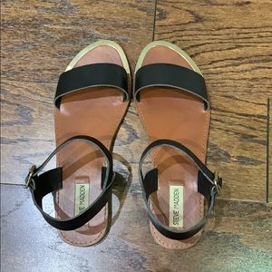 Steve Madden black sandals with gold accent.